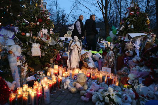 Mourners visit a streetside memorial for 20 children who were killed at Sandy Hook Elementary School on December 20, 2012 in Newtown, Connecticut.